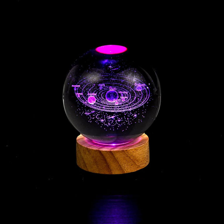 The Snoogg 3D Art Display crystal ball showcases a 3D in a crystal ball, illuminated by a colourful RGB light base (remote included) on a 3.5" wood stand. (Design-Solar System)